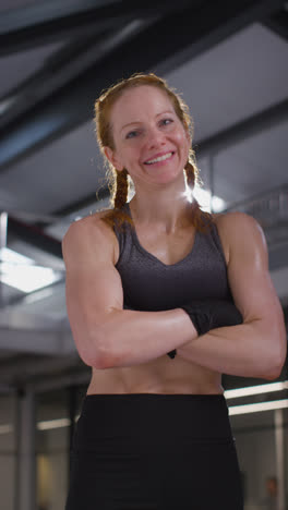 Vertical-Video-Portrait-Of-Smiling-Mature-Woman-Wearing-Fitness-Clothing-Standing-In-Gym-Ready-To-Exercise-2